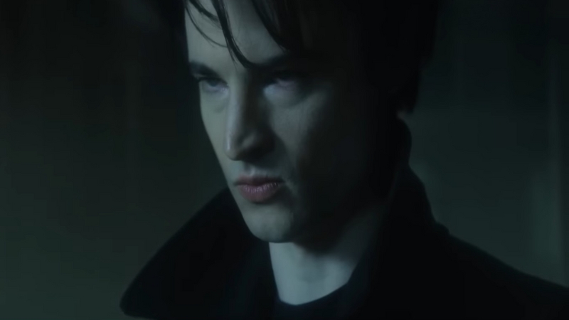 A close-up of Dream from The Sandman shows his intense expression in a dark