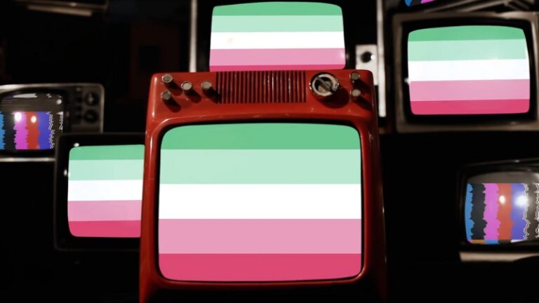 A set of retro TVs displays the abrosexual flag on their screens