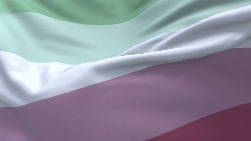 A close-up of the abrosexual flag with soft folds in the fabric